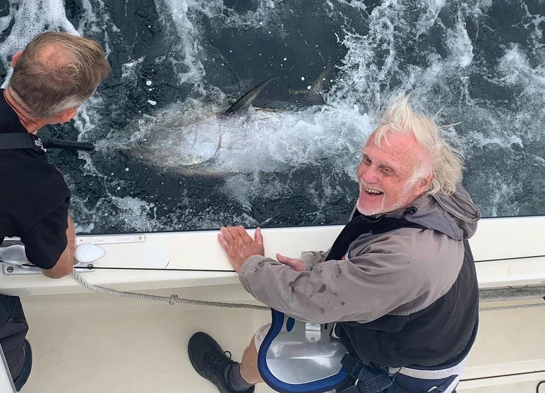 True Blue’s crew alongside a bluefin tuna at the side of the boat